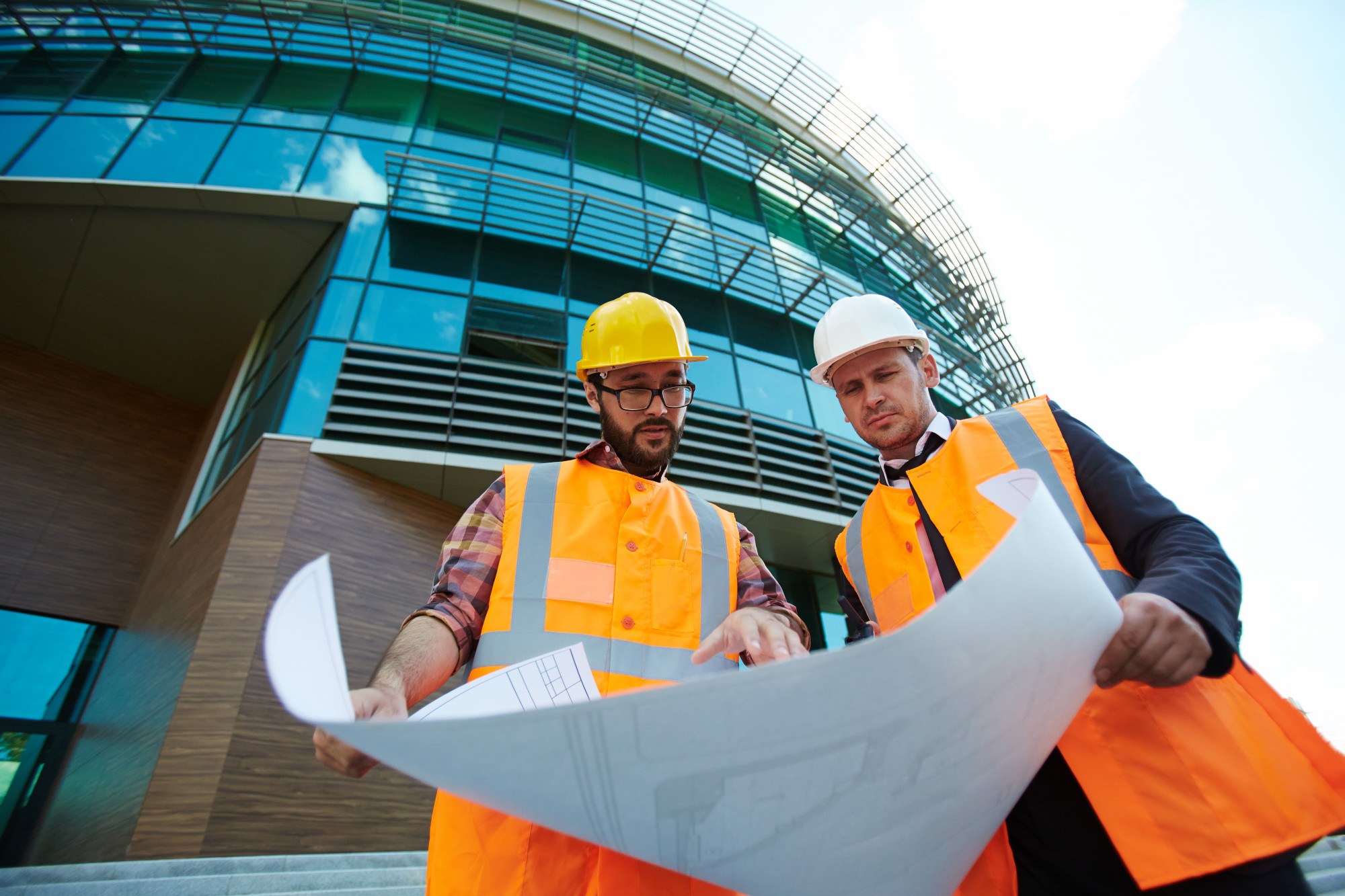 CS Group engineers reviewing project drawings on site in Abu Dhabi